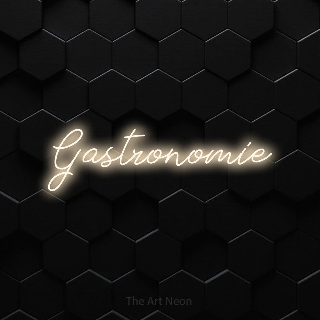 “Gastronomie” LED neon sign in warm white, with cursive lettering, shown against black hexagonal wall tiles.