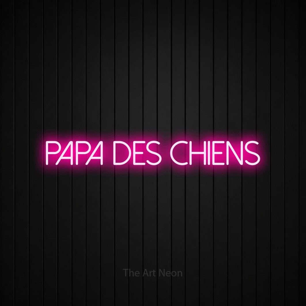 “Papa des chiens” LED neon sign in hot pink, with thin sans-serif lettering, shown against black vertical wall slats.