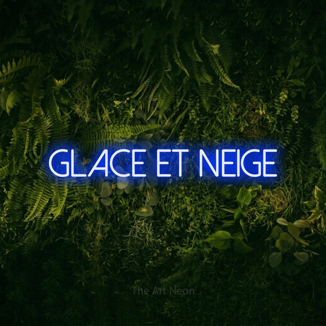 “Glace et neige” LED neon sign in blue, with thin sans-serif lettering, shown against a dark moss and forest backdrop.