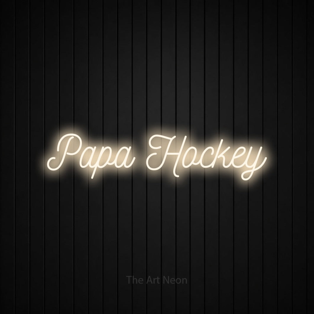“Papa hockey” LED neon sign in warm white, with ornate cursive lettering, shown against black vertical wall slats.