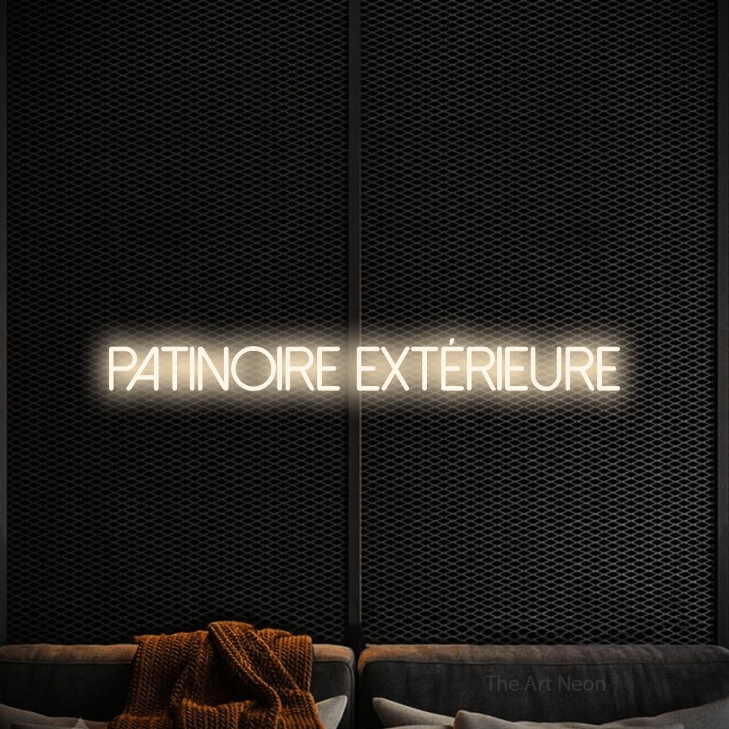 “Patinoire extérieure” LED neon sign in warm white, with thin sans-serif lettering, shown against a modern dark-toned seating area.