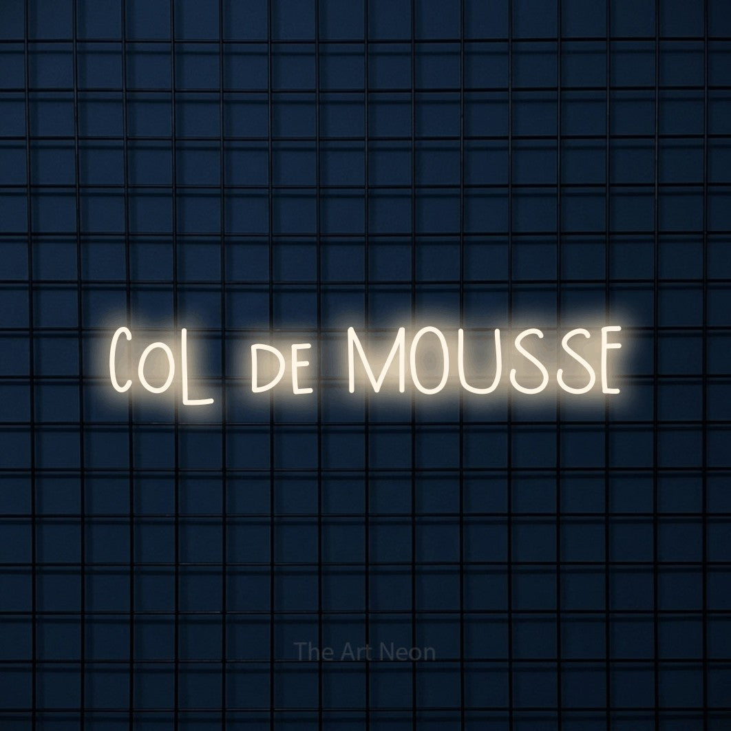 “Col de mousse” LED neon sign in warm white, with narrow hand-drawn lettering, shown against a dark blue grid.