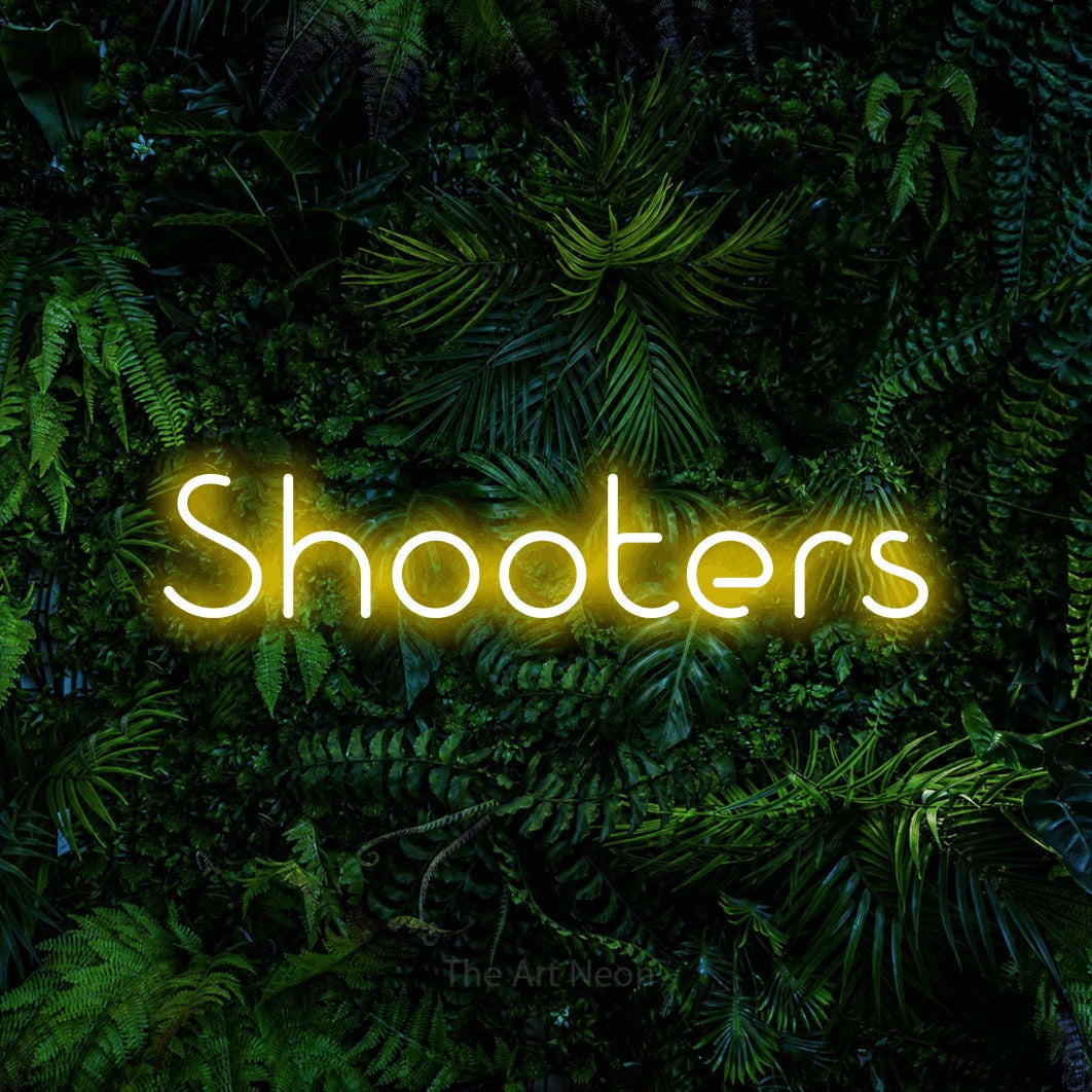 “Shooters” LED neon sign in yellow, with stylised geometric lettering, shown against dense tropical foliage.