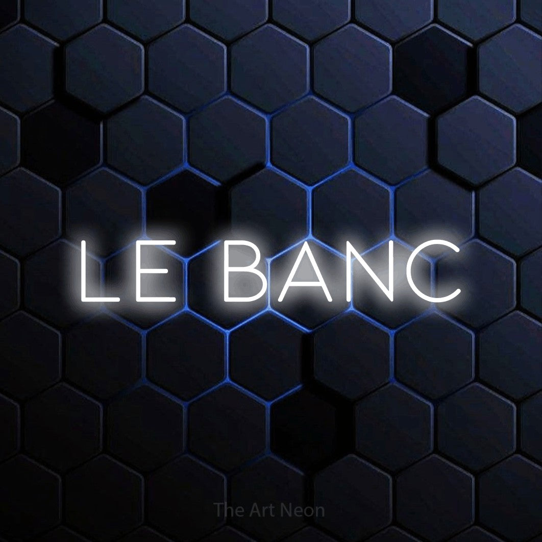 “Le banc” LED neon sign in cool white, with thin, widely spaced lettering, shown against a dark blue honeycomb pattern.