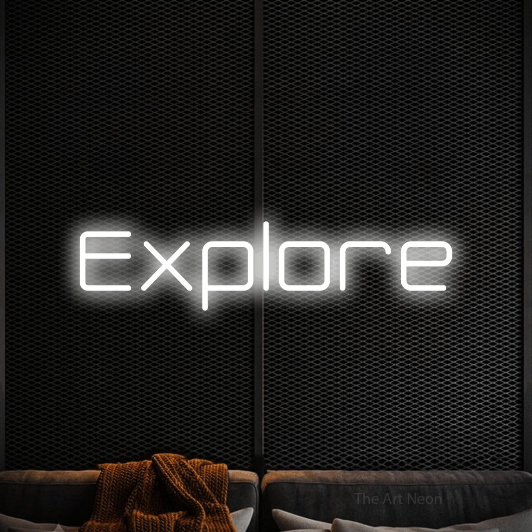 “Explore” LED neon sign in cool white, with rounded geometric lettering, shown against a modern dark-toned seating area.