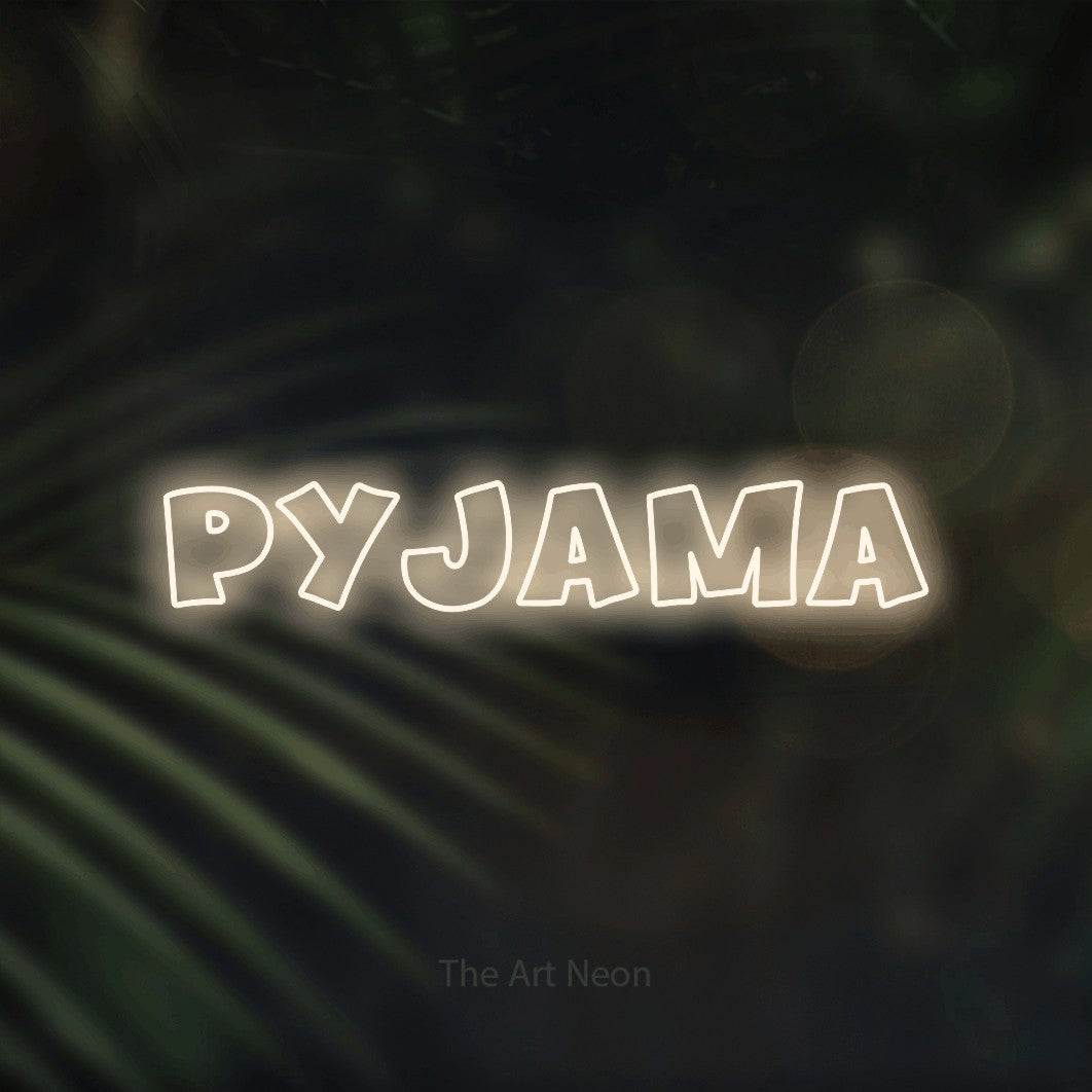 “Pyjama” LED neon sign in warm white, with wide lettering with irregular outlines, shown against a blurred palm and bokeh-light backdrop.