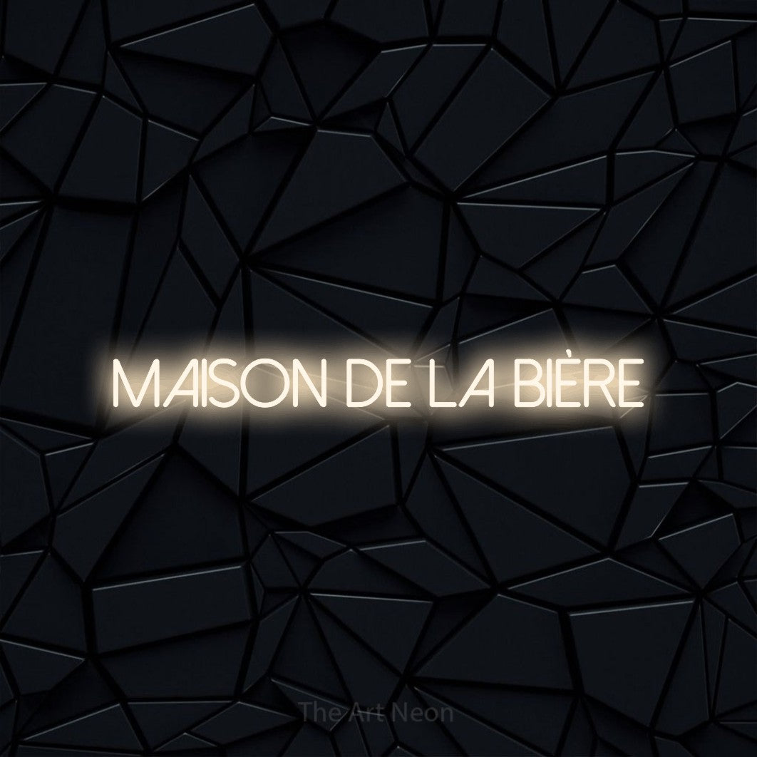 “Maison de la bière” LED neon sign in warm white, with thin sans-serif lettering, shown against a black polygonal surface.