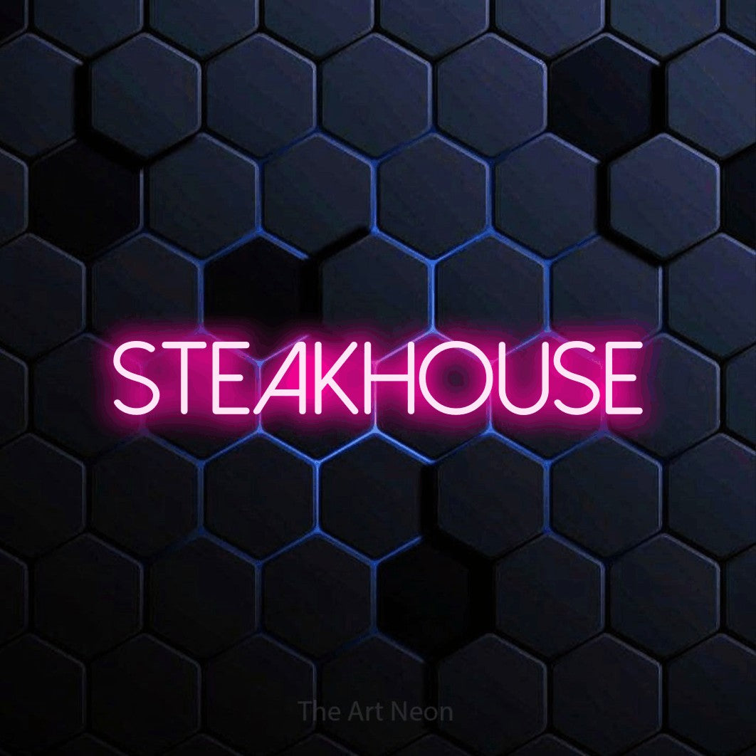 “Steakhouse” LED neon sign in hot pink, with thin sans-serif lettering, shown against a dark blue honeycomb pattern.