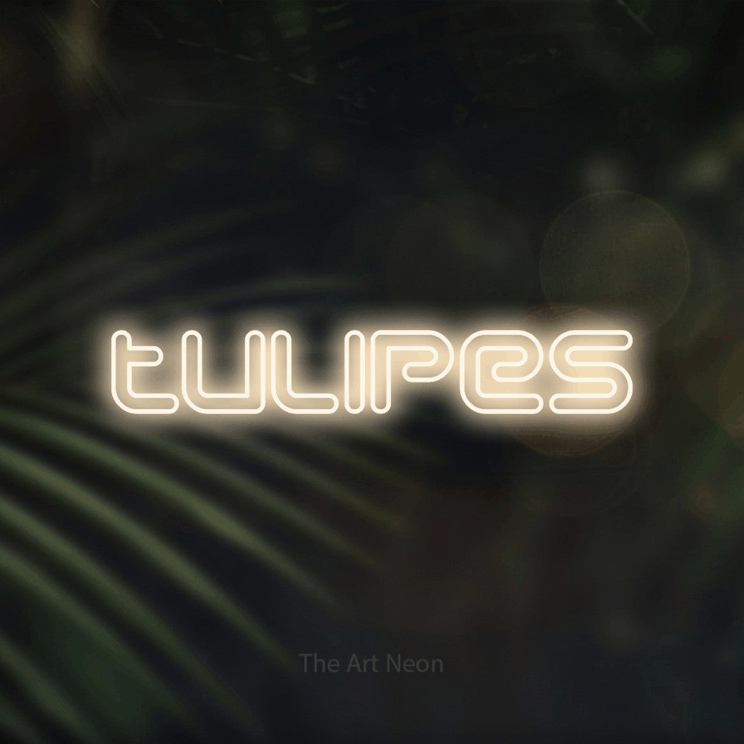 “Tulipes” LED neon sign in warm white, with futuristic double-line lettering, shown against a blurred palm and bokeh-light backdrop.