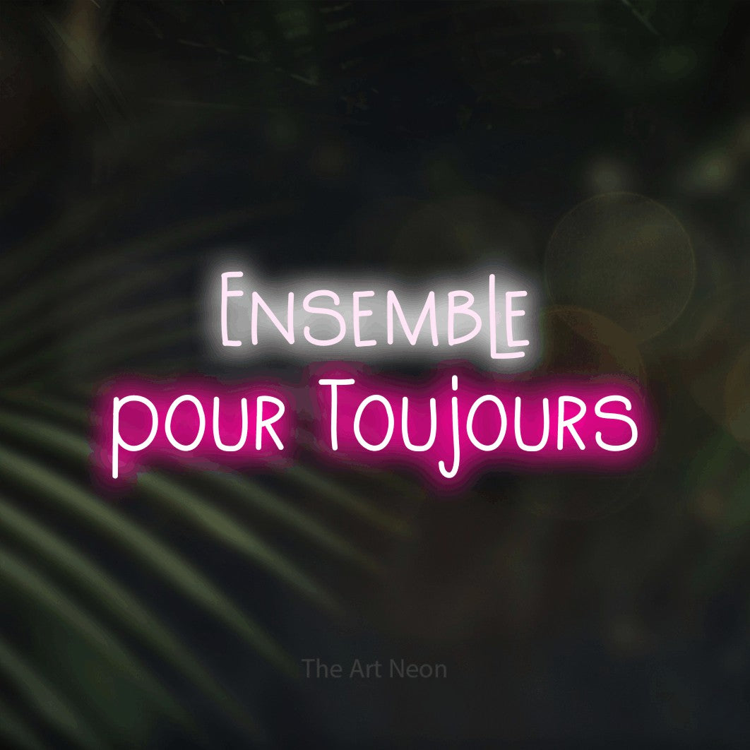 “Ensemble pour toujours” LED neon sign in cool white on the upper line and hot pink on the lower line, with narrow hand-drawn lettering across 2 lines, shown against a blurred palm and bokeh-light backdrop.