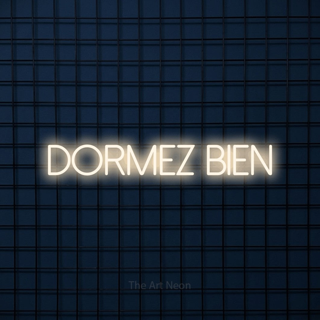 “Dormez bien” LED neon sign in warm white, with thin sans-serif lettering, shown against a dark blue grid.