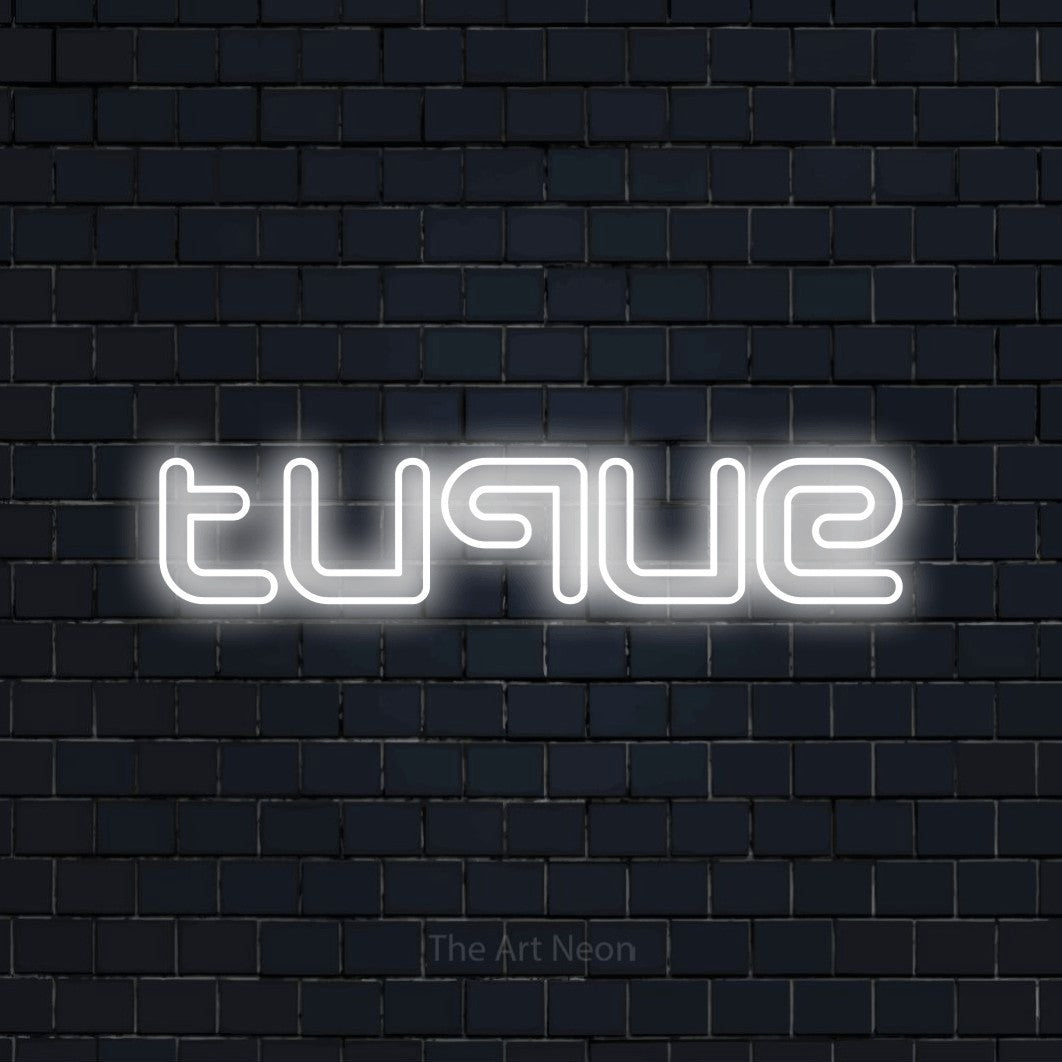“Tuque” LED neon sign in cool white, with futuristic double-line lettering, shown against a dark navy brick wall.