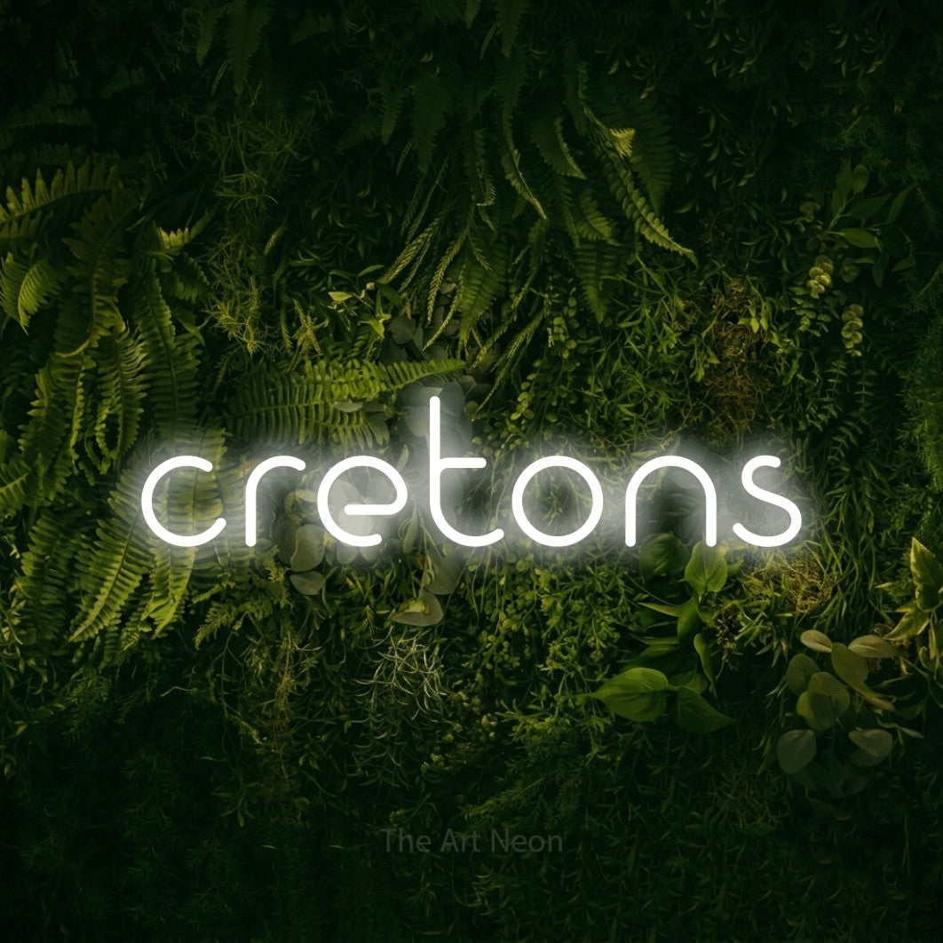 “Cretons” LED neon sign in cool white, with stylised geometric lettering, shown against a dark moss and forest backdrop.