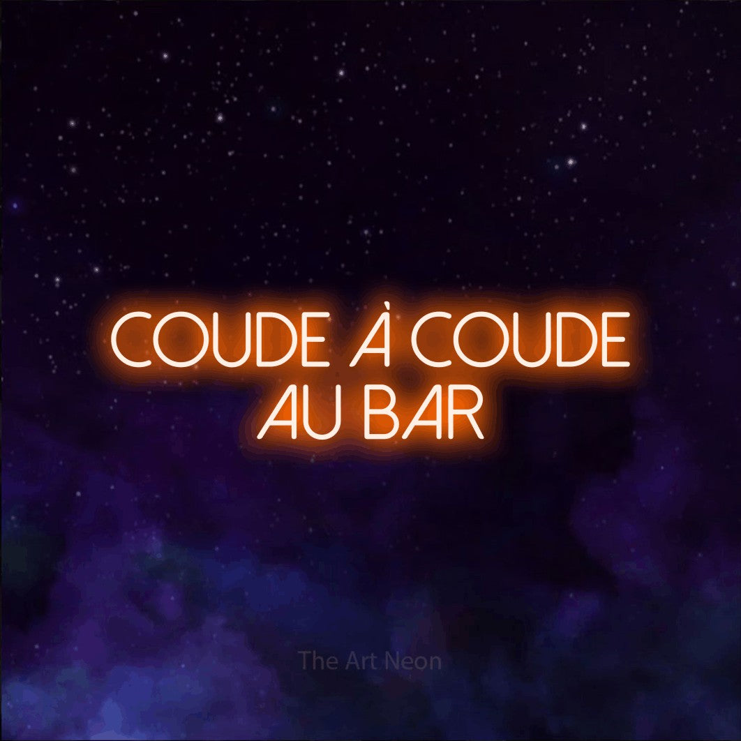 “Coude à coude au bar” LED neon sign in orange, with thin sans-serif lettering across 2 lines, shown against a purple galaxy backdrop.