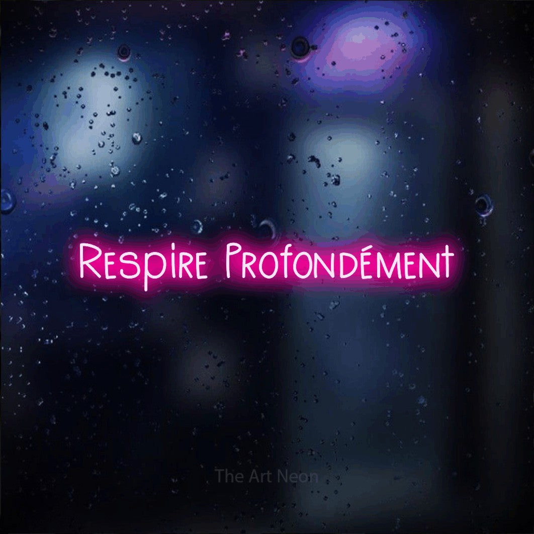 “Respire profondément” LED neon sign in hot pink, with narrow hand-drawn lettering, shown against glass with blue and purple reflections.