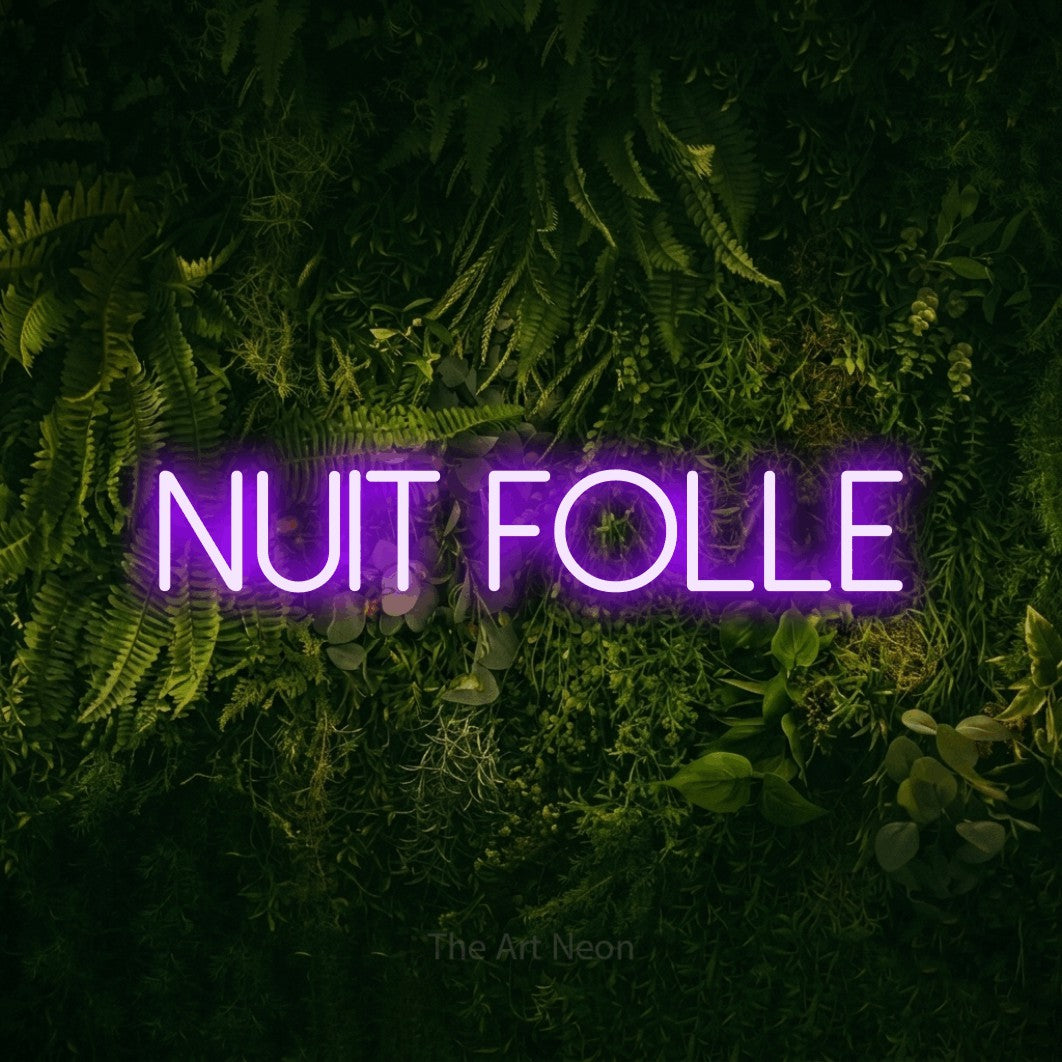“Nuit folle” LED neon sign in purple, with thin sans-serif lettering, shown against a dark moss and forest backdrop.