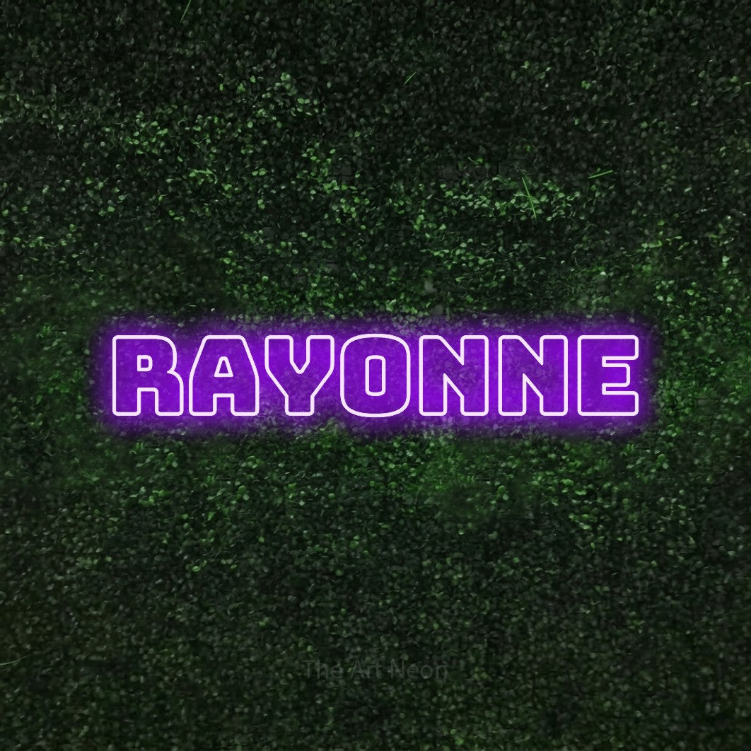 “Rayonne” LED neon sign in purple, with bold outline lettering, shown against a textured green hedge.