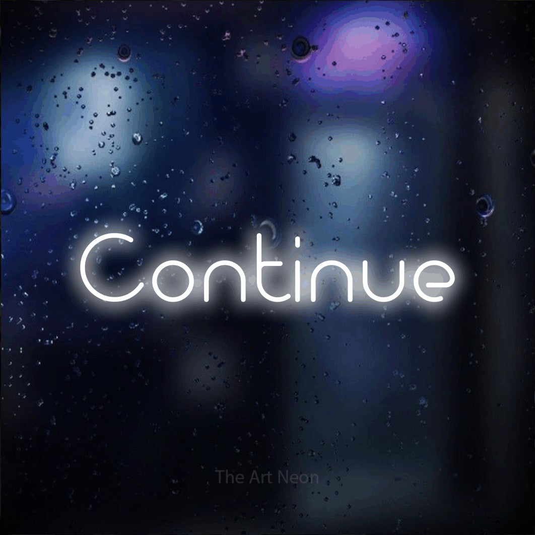 “Continue” LED neon sign in cool white, with stylised geometric lettering, shown against glass with blue and purple reflections.