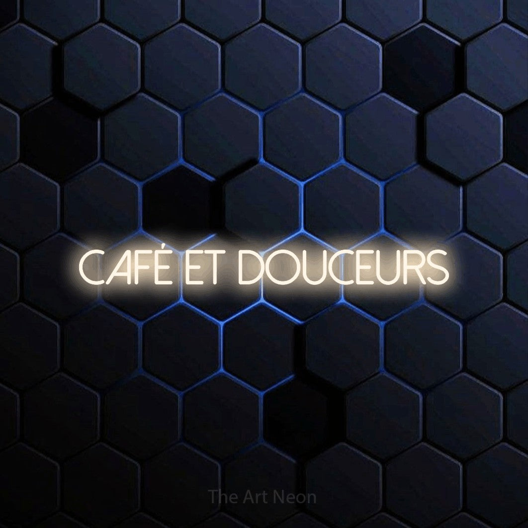 “Café et douceurs” LED neon sign in warm white, with thin sans-serif lettering, shown against a dark blue honeycomb pattern.