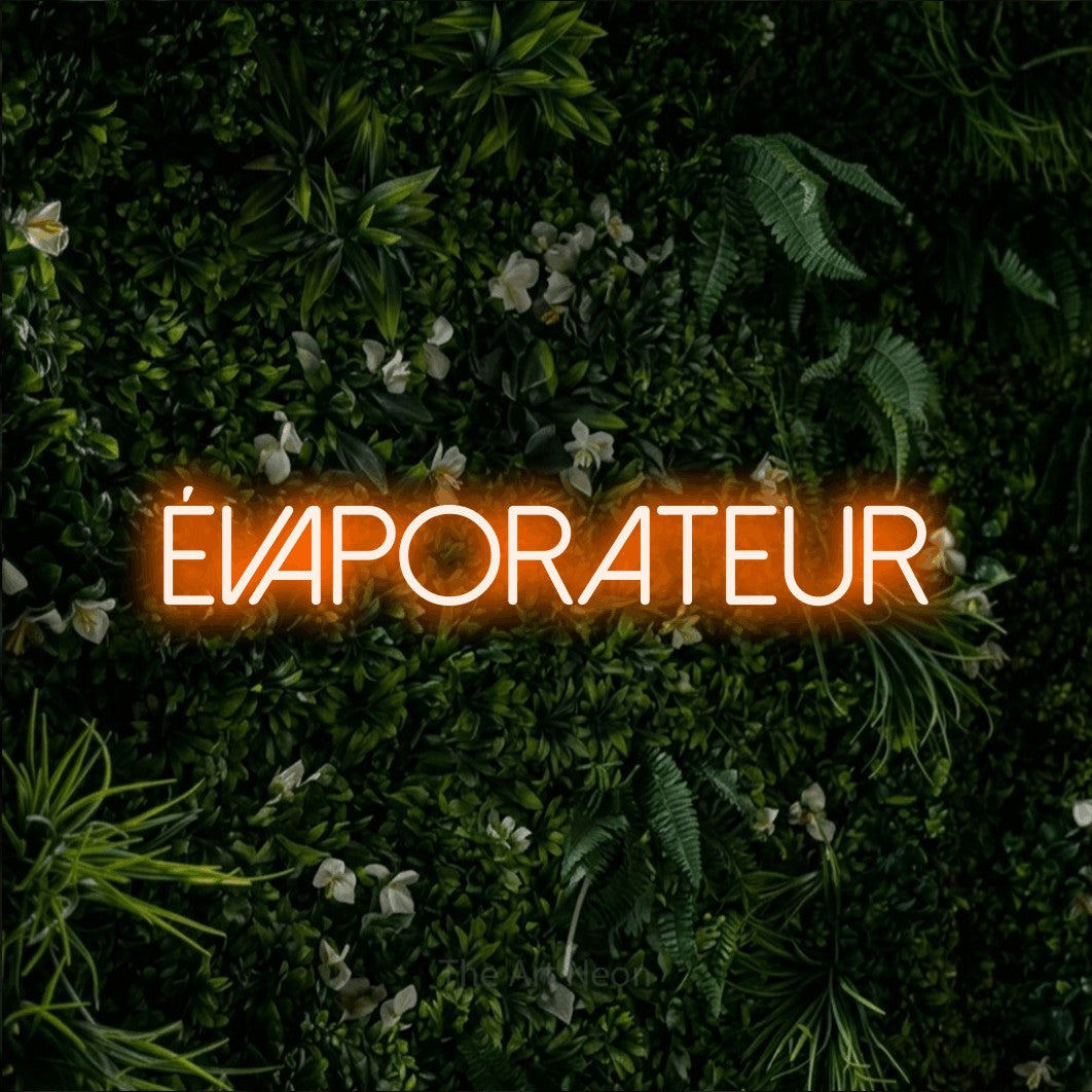 “Évaporateur” LED neon sign in orange, with thin sans-serif lettering, shown against a dense green plant wall.