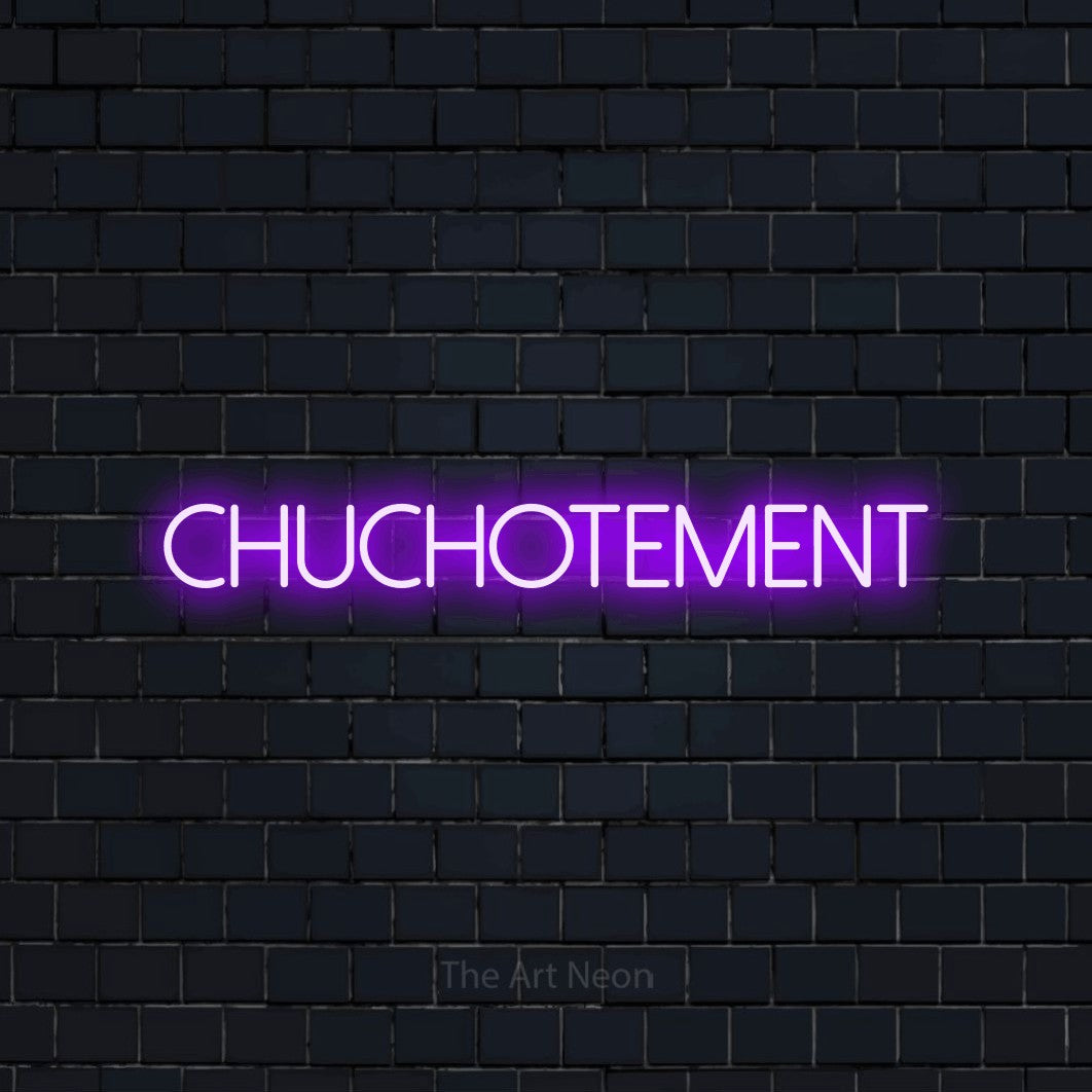 “Chuchotement” LED neon sign in purple, with thin sans-serif lettering, shown against a dark navy brick wall.
