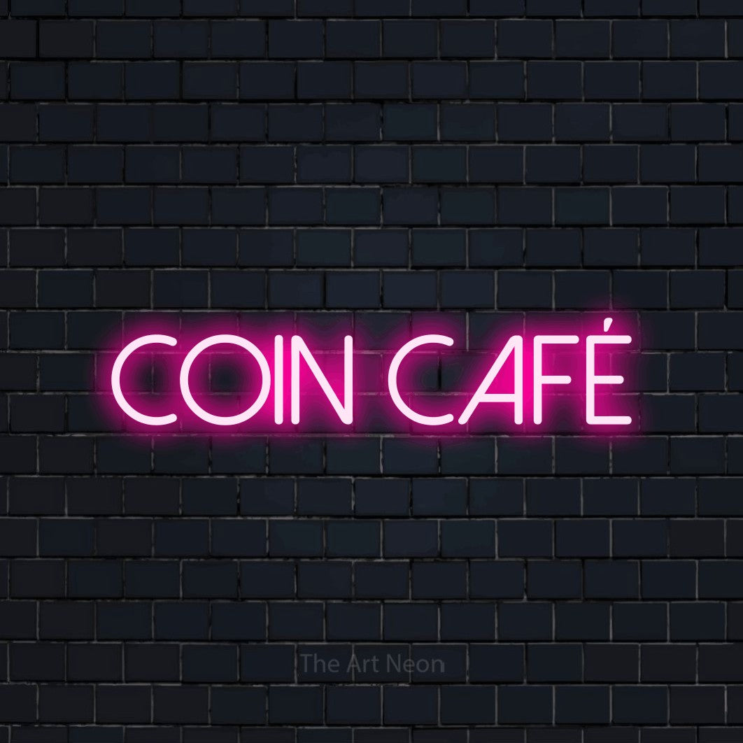 Lettrage en néon LED « Coin café » en rose vif, en lettres fines sans empattement, présenté sur un mur de briques bleu marine foncé, pour une cuisine.