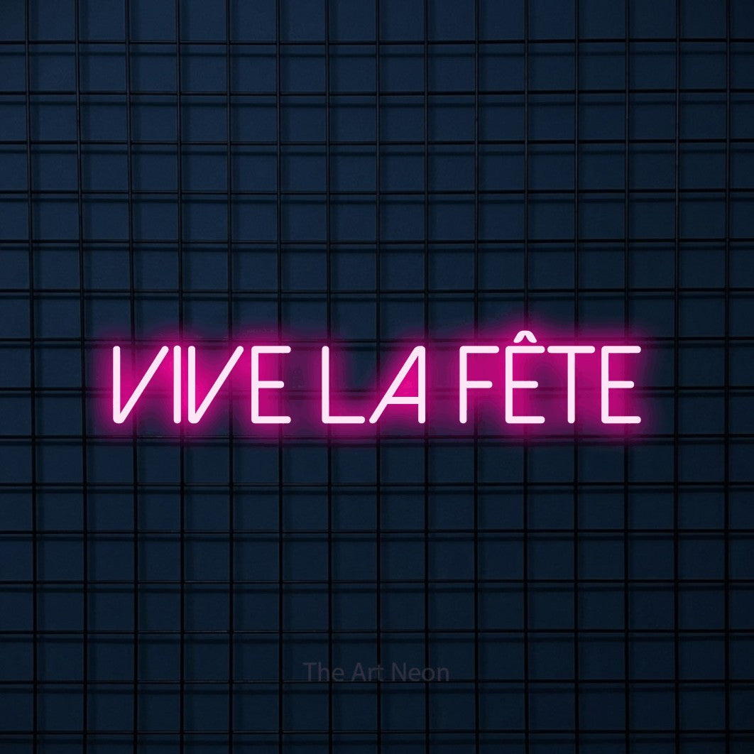 “Vive la fête” LED neon sign in hot pink, with thin sans-serif lettering, shown against a dark blue grid.
