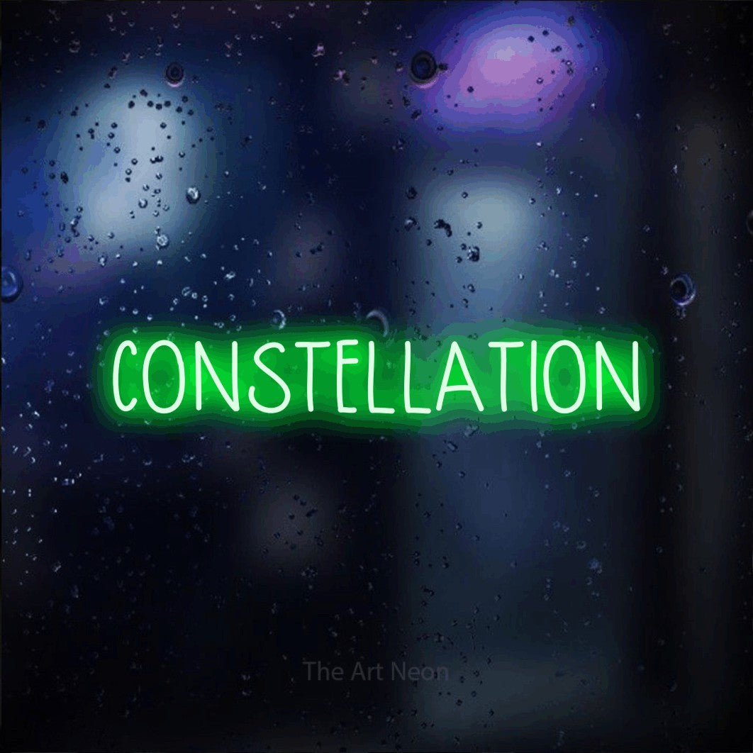 “Constellation” LED neon sign in green, with narrow hand-drawn lettering, shown against glass with blue and purple reflections.