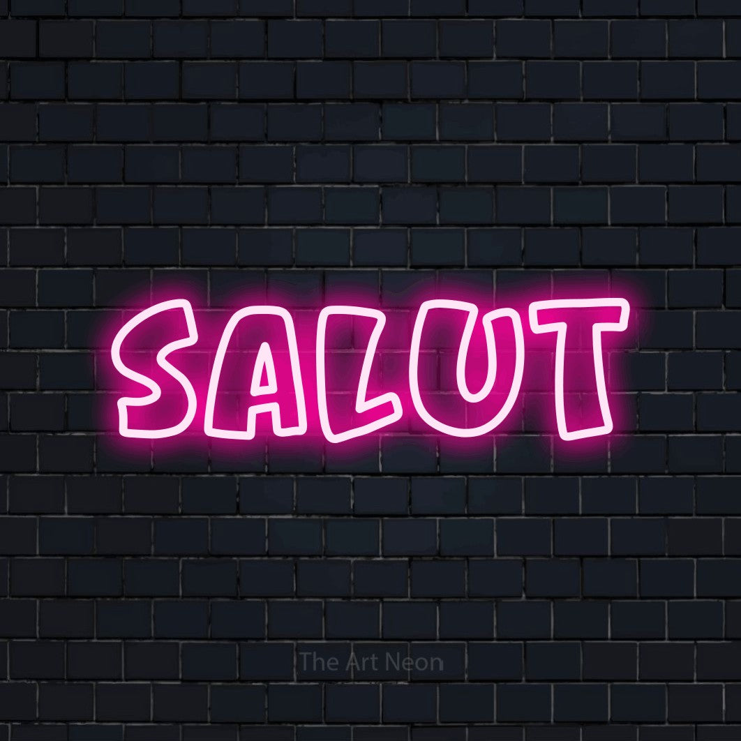 “Salut” LED neon sign in hot pink, with rounded outline lettering, shown against a dark navy brick wall.