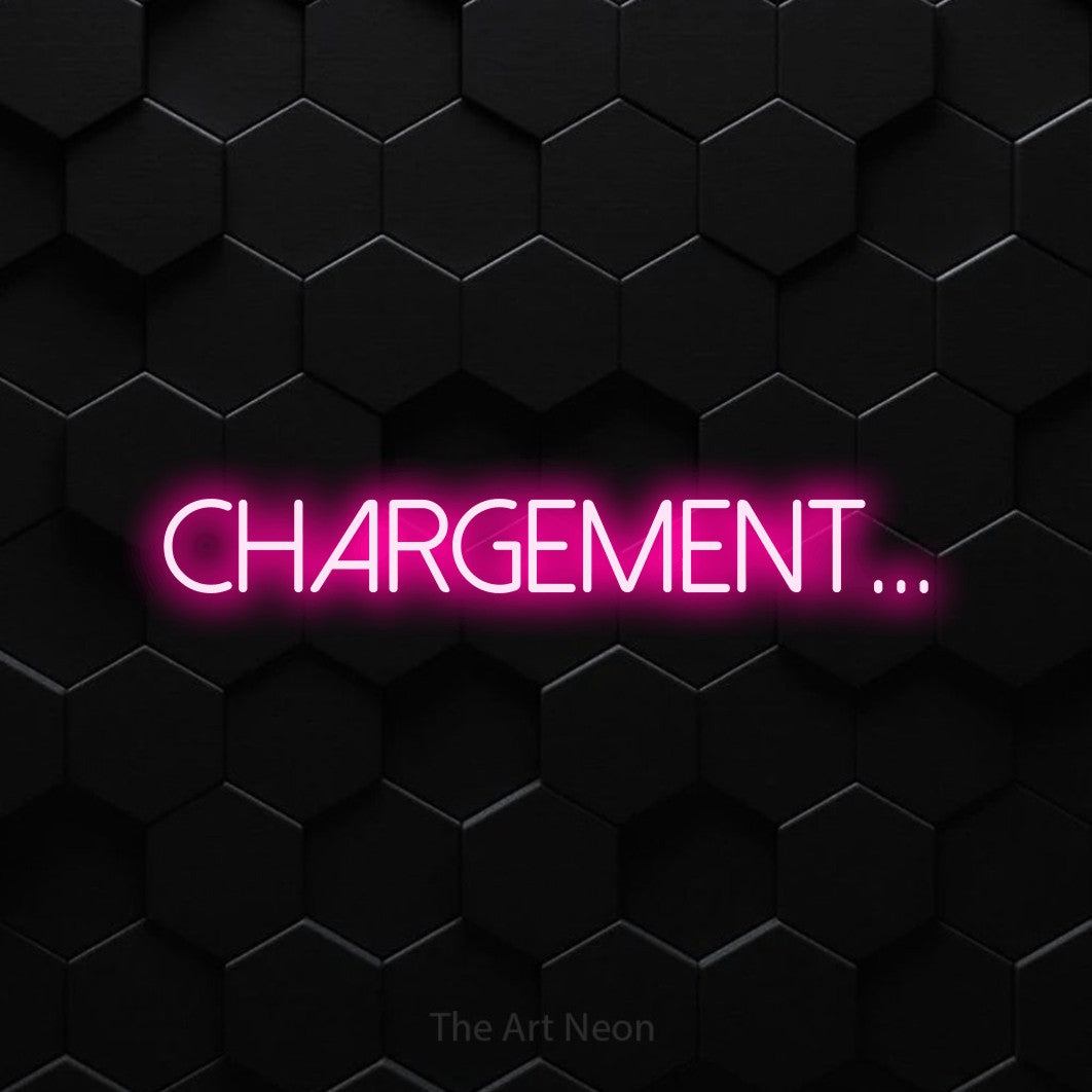 “Chargement...” LED neon sign in hot pink, with thin sans-serif lettering, shown against black hexagonal wall tiles.