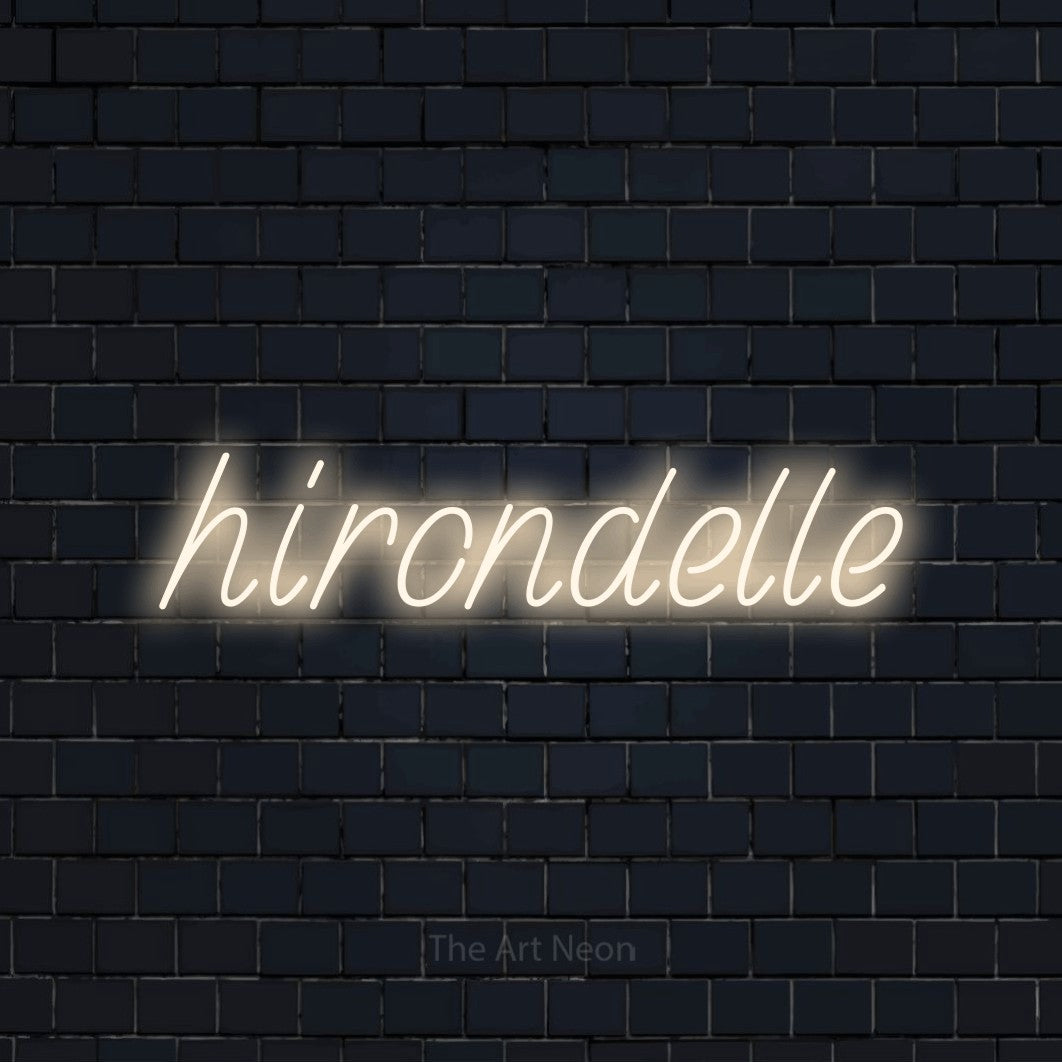 “Hirondelle” LED neon sign in warm white, with slanted handwritten lettering, shown against a dark navy brick wall.
