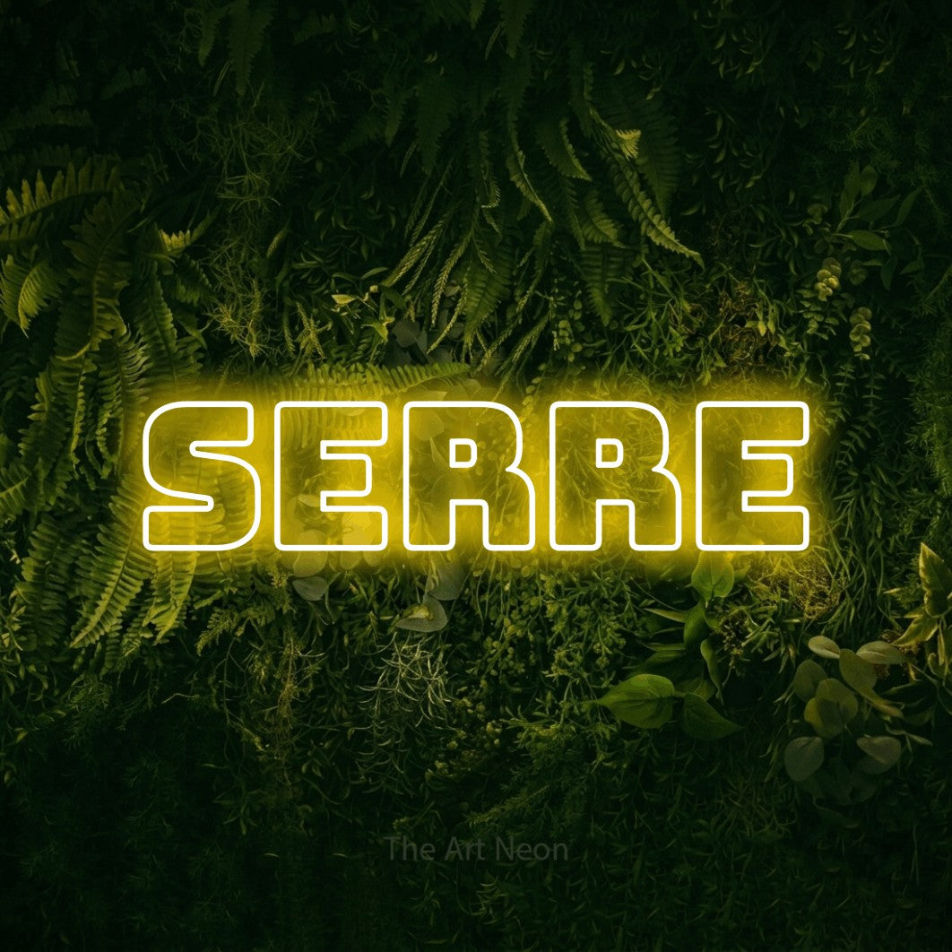 “Serre” LED neon sign in yellow, with bold outline lettering, shown against a dark moss and forest backdrop.