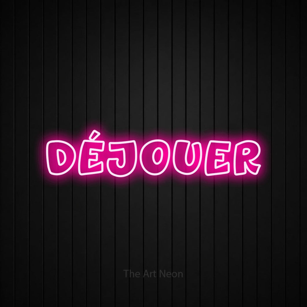 “Déjouer” LED neon sign in hot pink, with rounded outline lettering, shown against black vertical wall slats.