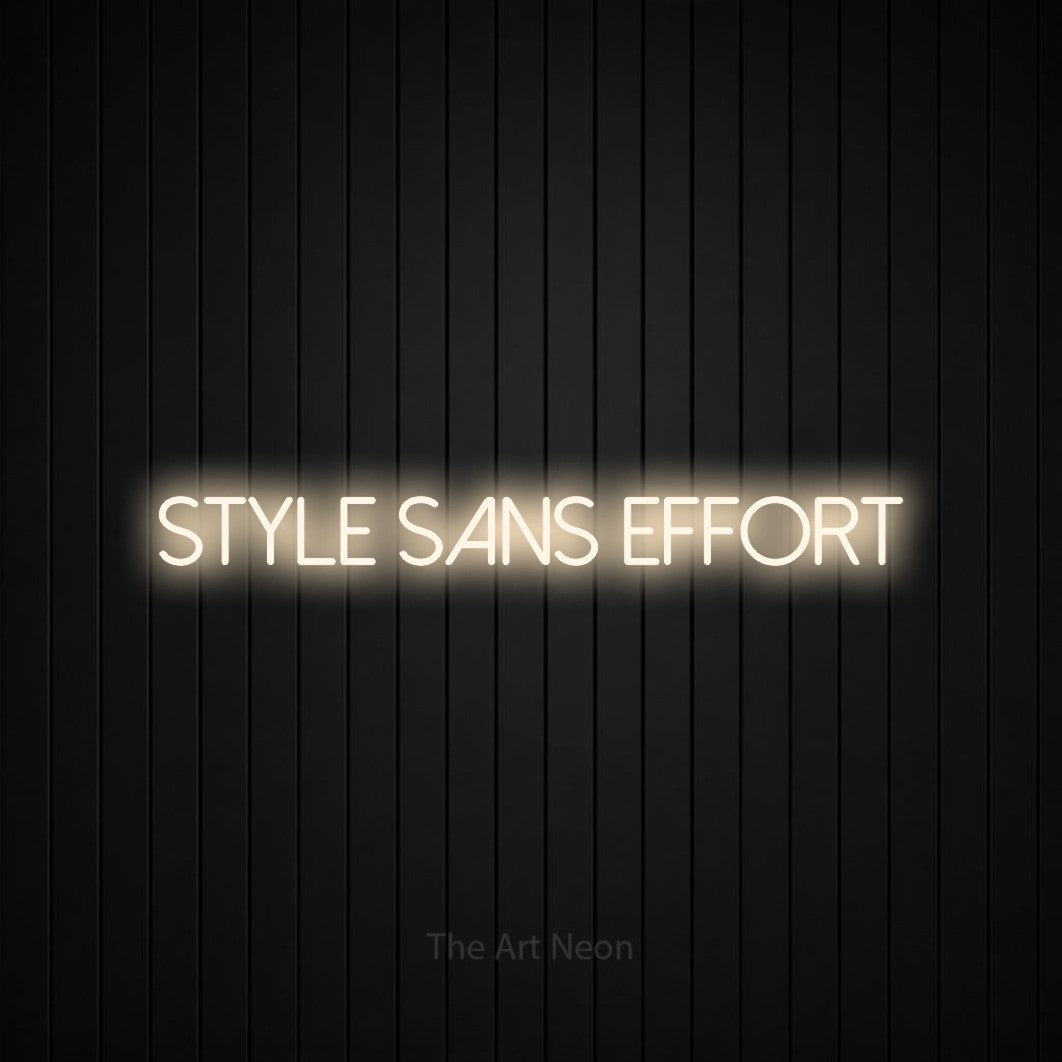 “Style sans effort” LED neon sign in warm white, with thin sans-serif lettering, shown against black vertical wall slats.