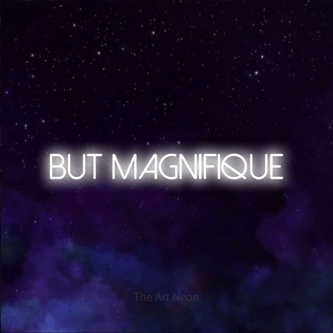 “But magnifique” LED neon sign in cool white, with thin sans-serif lettering, shown against a purple galaxy backdrop.