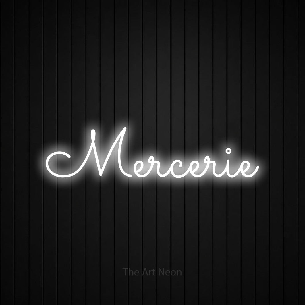 “Mercerie” LED neon sign in cool white, with looped cursive lettering, shown against black vertical wall slats.