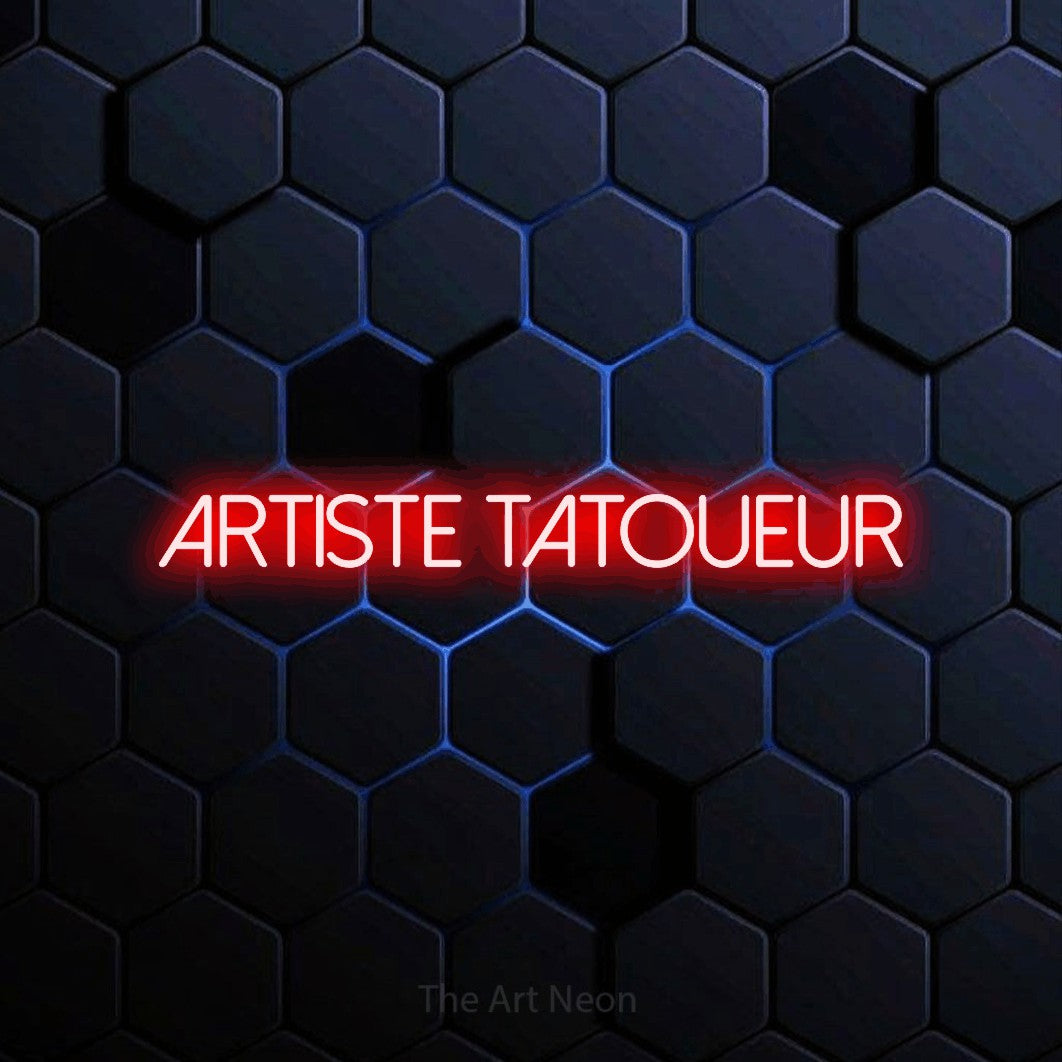 “Artiste tatoueur” LED neon sign in red, with thin sans-serif lettering, shown against a dark blue honeycomb pattern.