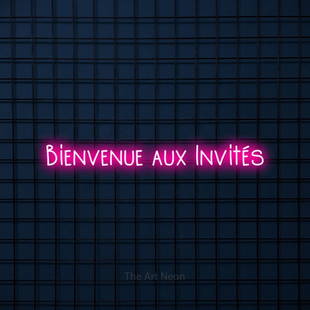 “Bienvenue aux invités” LED neon sign in hot pink, with narrow hand-drawn lettering, shown against a dark blue grid.
