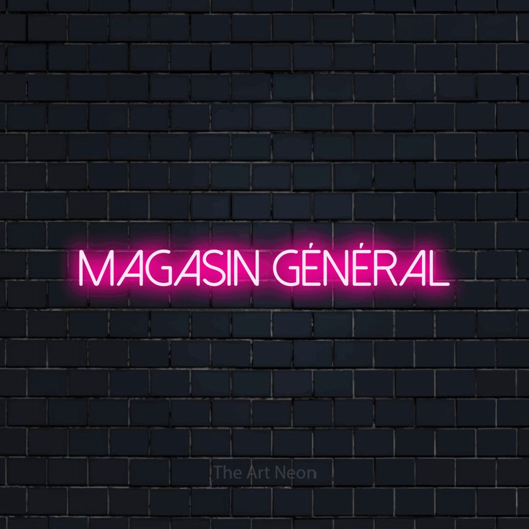 “Magasin général” LED neon sign in hot pink, with thin sans-serif lettering, shown against a dark navy brick wall.