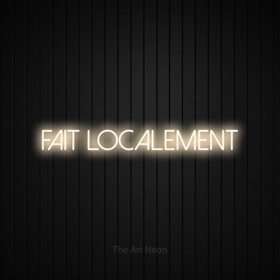 “Fait localement” LED neon sign in warm white, with thin sans-serif lettering, shown against black vertical wall slats.
