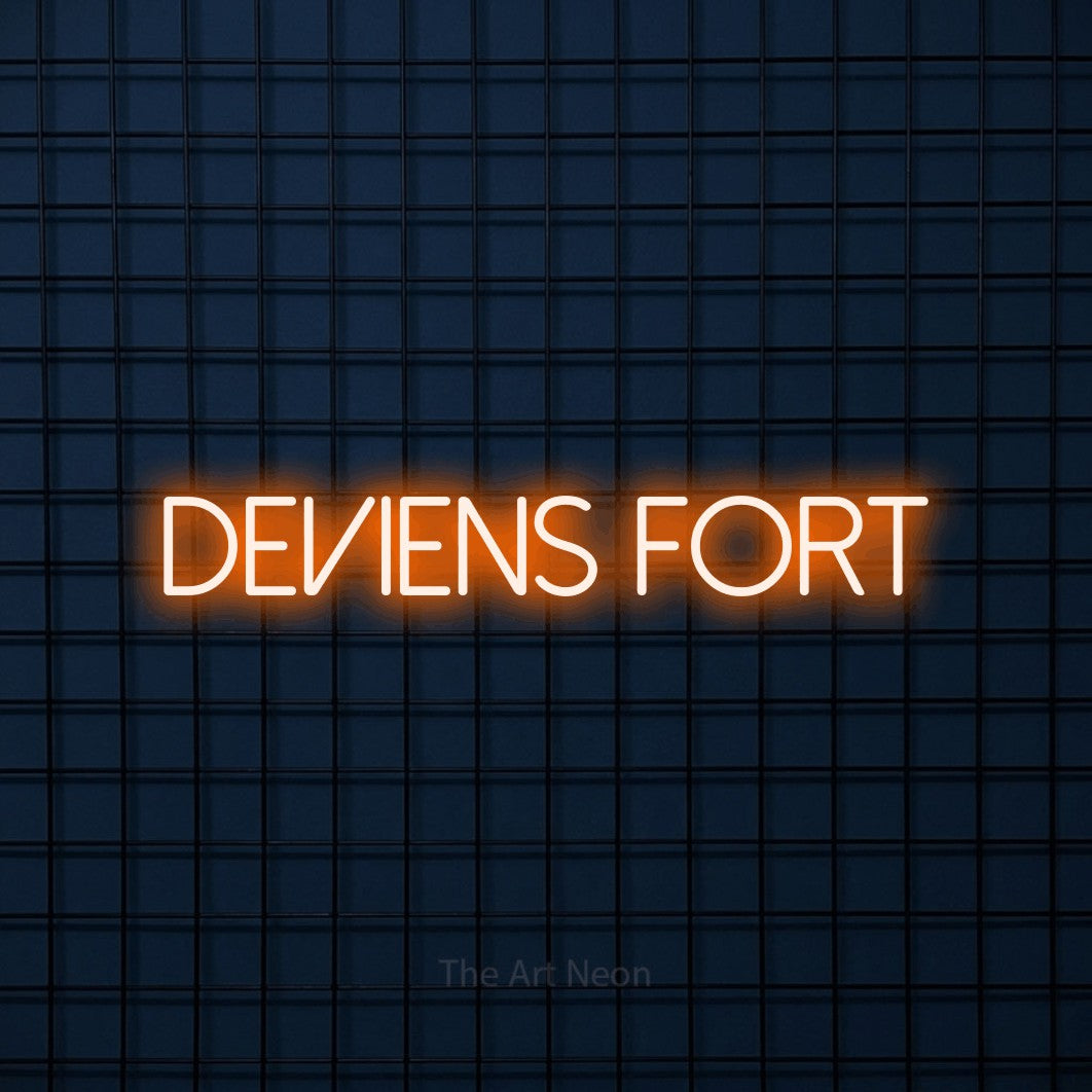 “Deviens fort” LED neon sign in orange, with thin sans-serif lettering, shown against a dark blue grid.