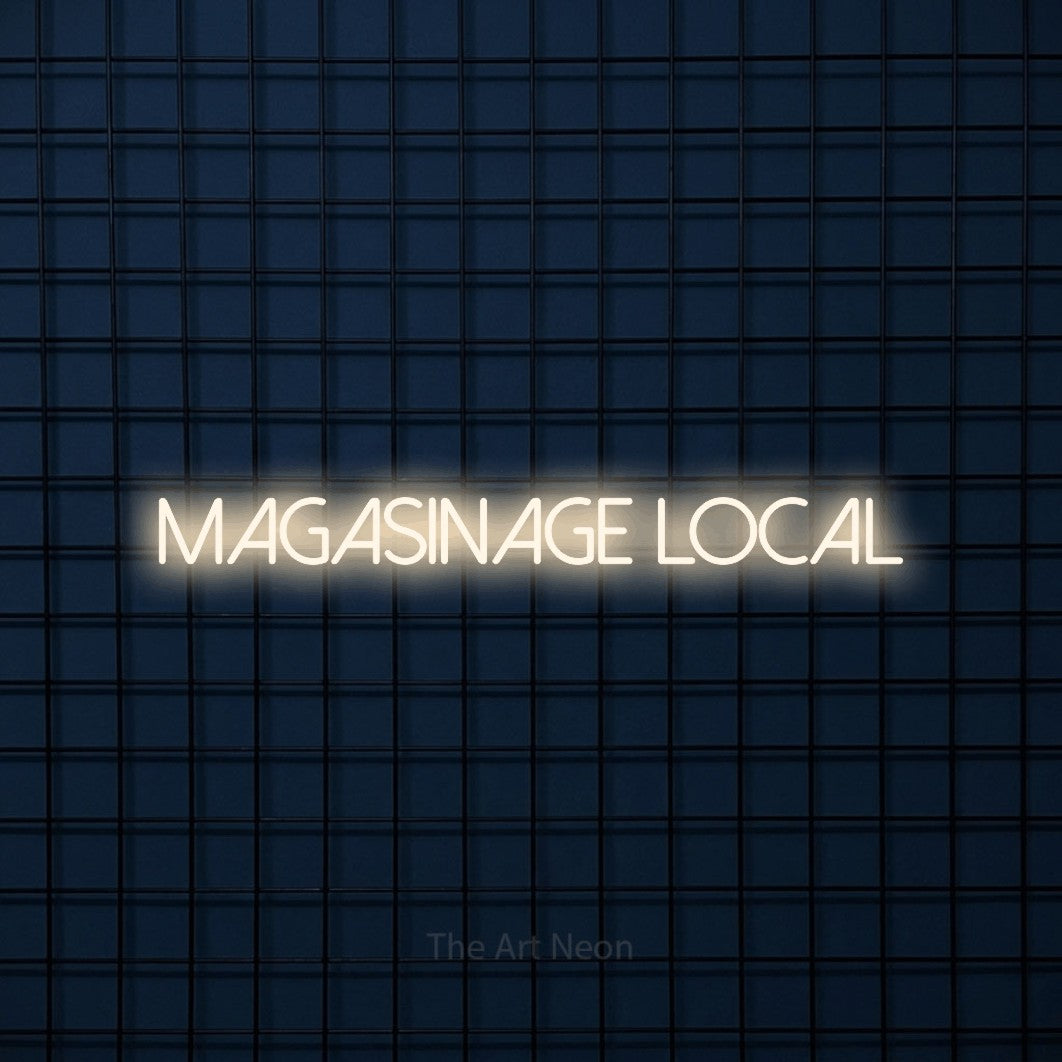 “Magasinage local” LED neon sign in warm white, with thin sans-serif lettering, shown against a dark blue grid.