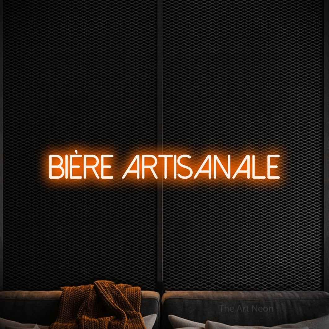 “Bière artisanale” LED neon sign in orange, with thin sans-serif lettering, shown against a modern dark-toned seating area.