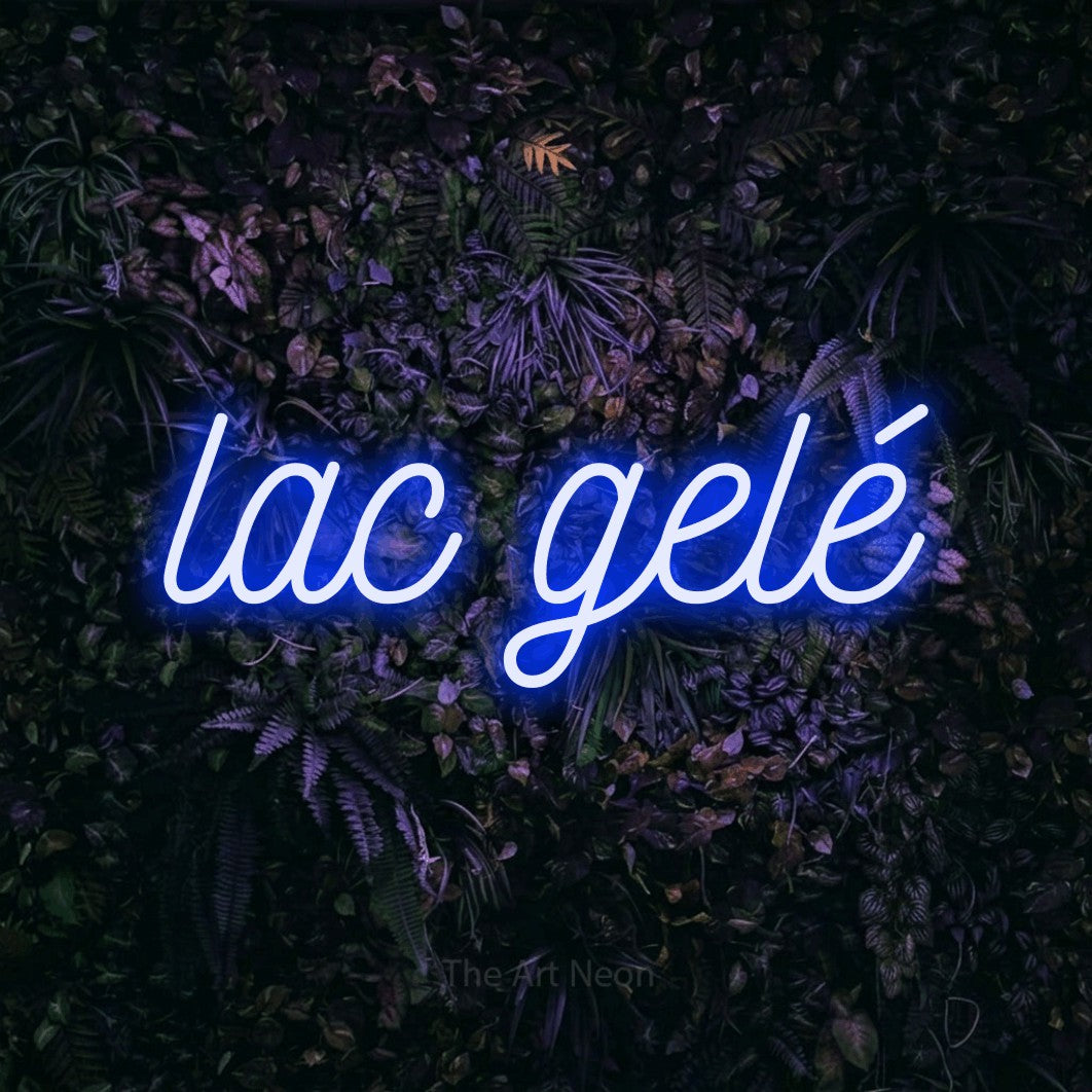 “Lac gelé” LED neon sign in blue, with ornate cursive lettering, shown against a dark wall with purple flowers.