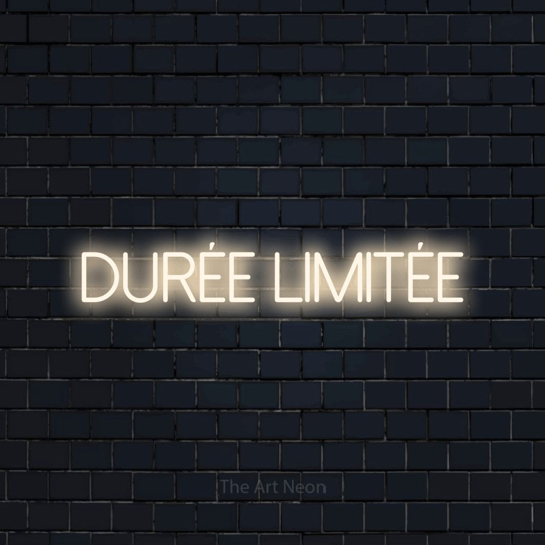 “Durée limitée” LED neon sign in warm white, with thin sans-serif lettering, shown against a dark navy brick wall.