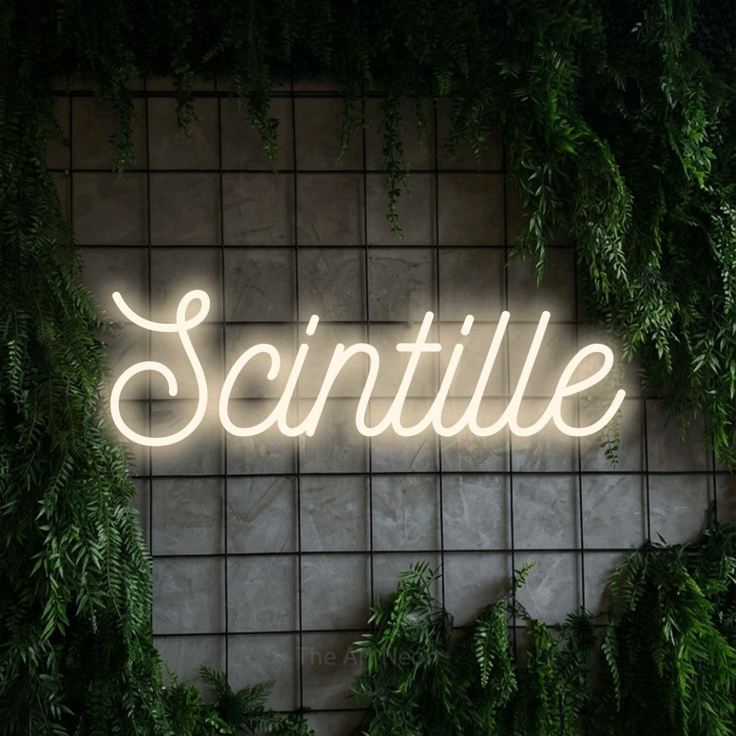 “Scintille” LED neon sign in warm white, with ornate cursive lettering, shown against an ivy-covered concrete grid.