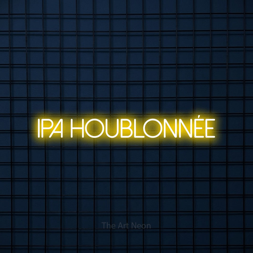 “IPA houblonnée” LED neon sign in yellow, with thin sans-serif lettering, shown against a dark blue grid.