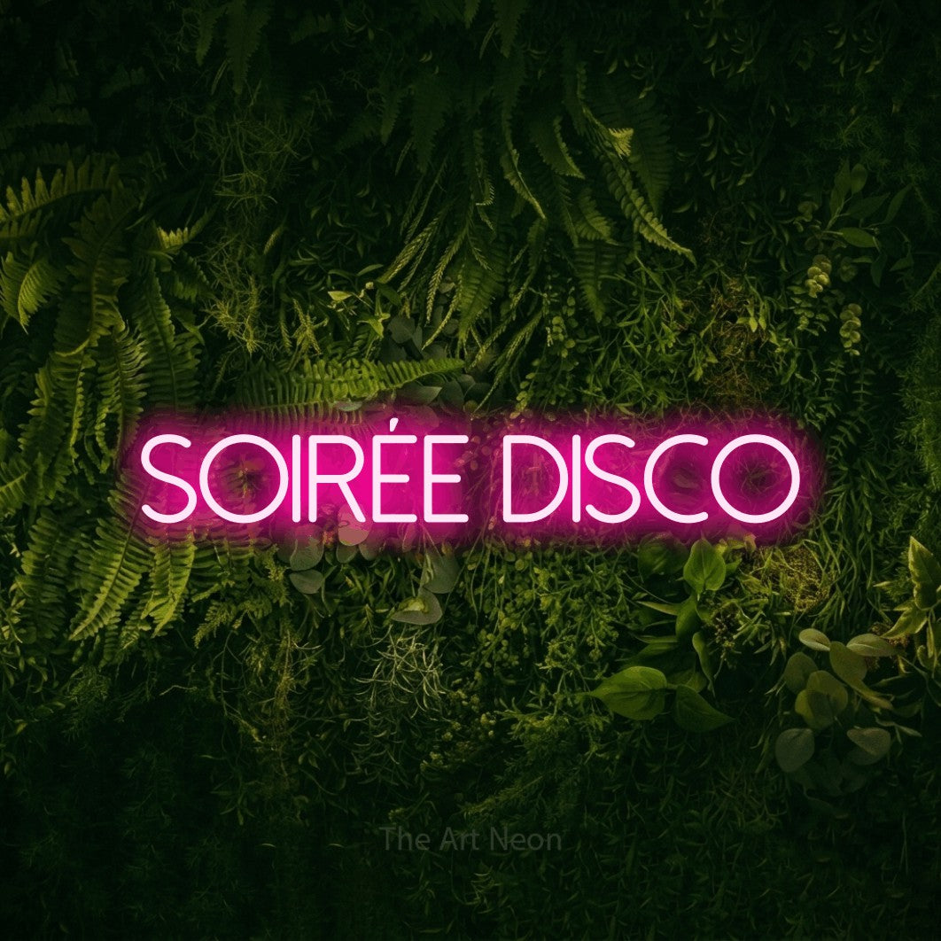 “Soirée disco” LED neon sign in hot pink, with thin sans-serif lettering, shown against a dark moss and forest backdrop.