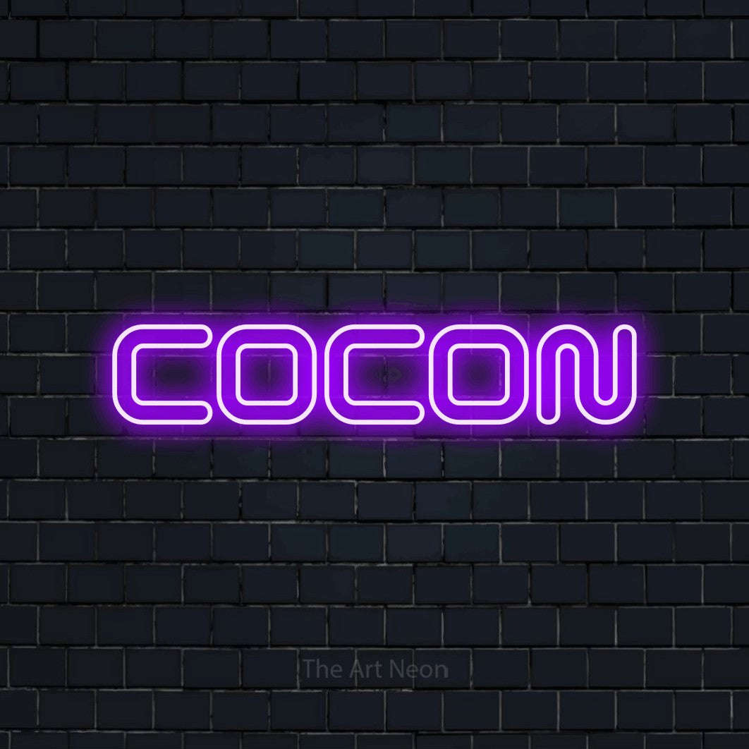 “Cocon” LED neon sign in purple, with futuristic double-line lettering, shown against a dark navy brick wall.