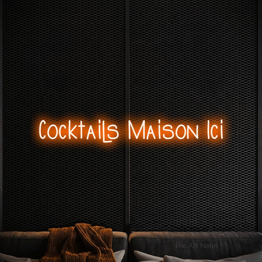 “Cocktails maison ici” LED neon sign in orange, with narrow hand-drawn lettering, shown against a modern dark-toned seating area.